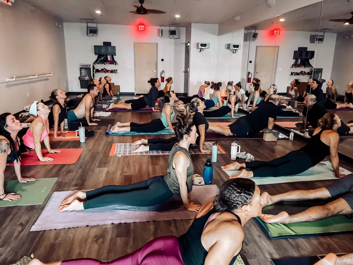 Full class flowing through cobra pose at Sumit's Hot Yoga KC